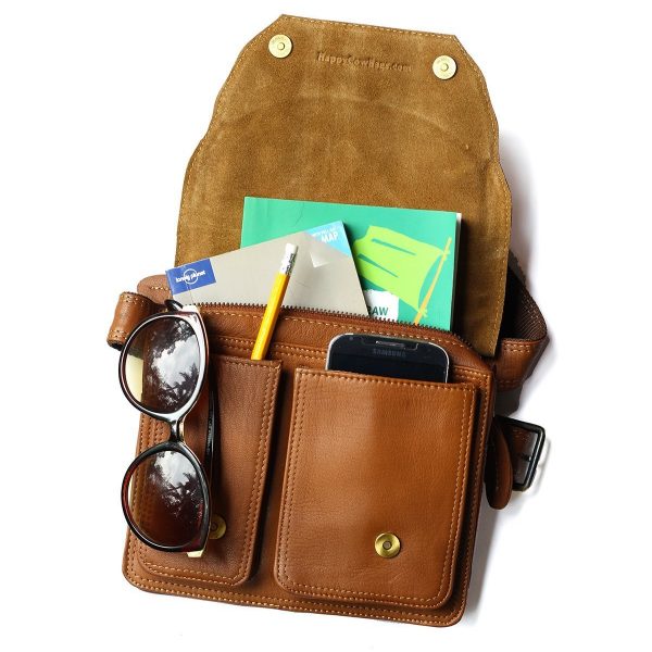 Burn Notice leather hip bag with compartments holding sunglasses, phone, and other items on a white background