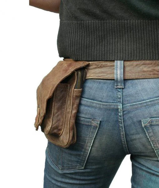 Person wearing a happy cow brown leather hip bag