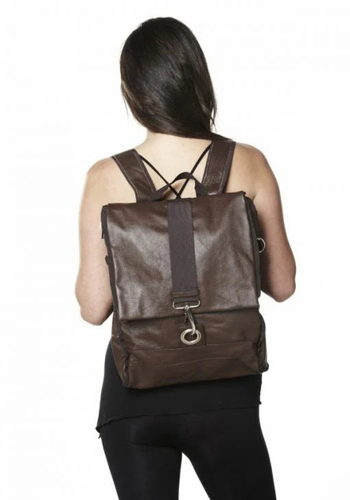 Woman wearing a brown backpack on a white background